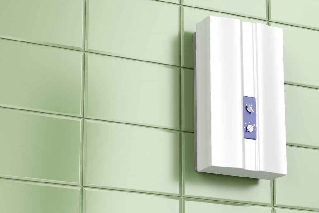 A tankless water heater on a green tile wall to illustrate Benefits Of Tankless Water Heater and plumbing considerations when building a house.