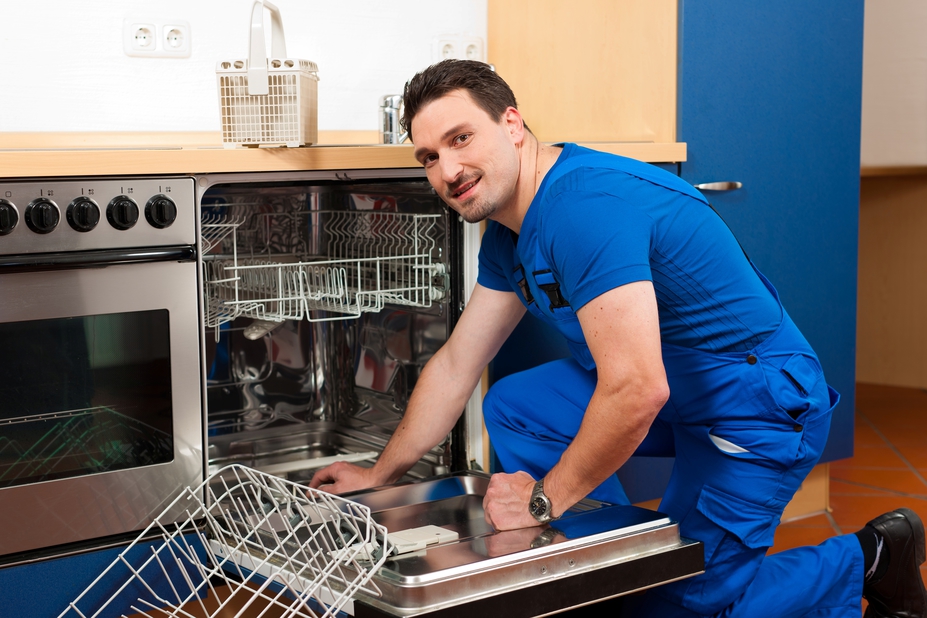 Plumber fixing a dishwasher