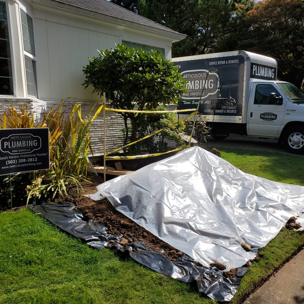 A large section of the lawn is covered by tarps and what looks to be a pile of dirt and a Meticulous Plumbing truck in the background to help illustrate main water line to house is leaking and how to find a water line leak to help illustrate How to Detect a Slab Leak