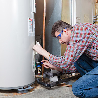 A plumber installing a water heater in Portland OR