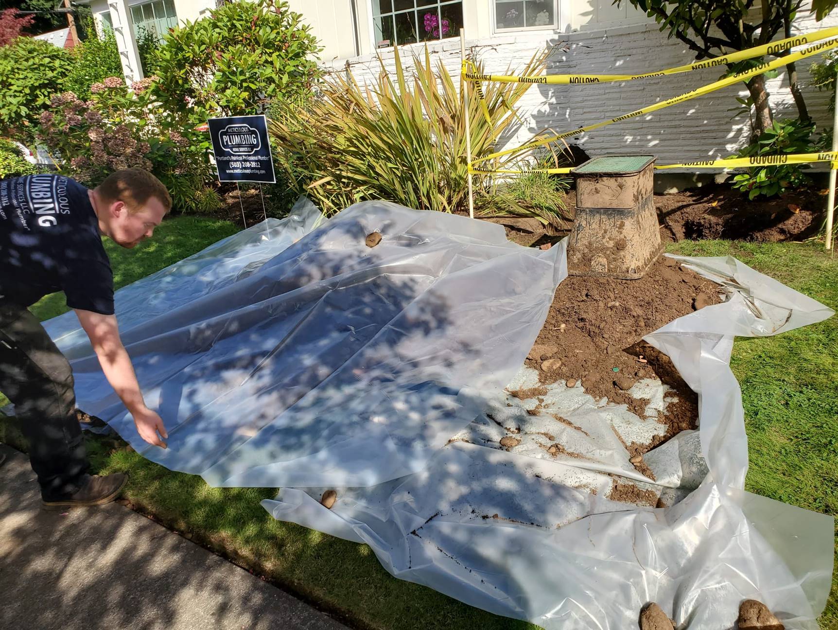Trenching for a new main water line into the house covered by a tarp to help illustrate main water line repair and how to find a water line leak.