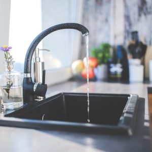 image of a kitchen faucet with water coming out