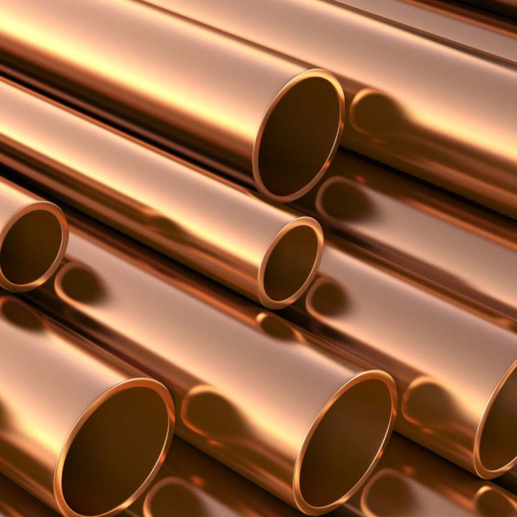 A stack of copper piping to help illustrate PEX vs Copper Pipe: The Side-By-Side Comparison and choosing pipe material for a home repipe